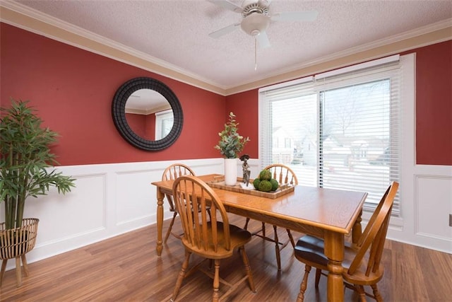 dining space featuring ornamental molding and hardwood / wood-style floors