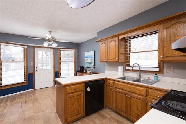 kitchen with a textured ceiling, black appliances, sink, kitchen peninsula, and ceiling fan