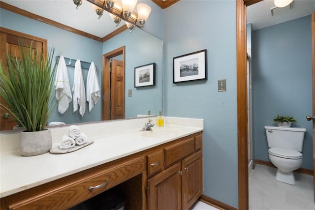 bathroom with toilet, vanity, and ornamental molding