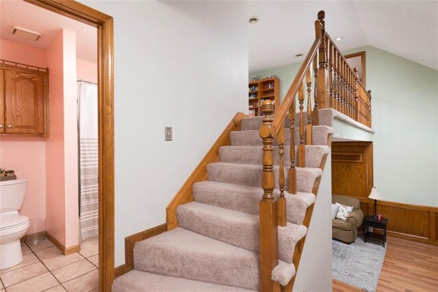 stairs featuring vaulted ceiling