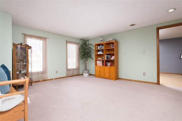 unfurnished room featuring light colored carpet