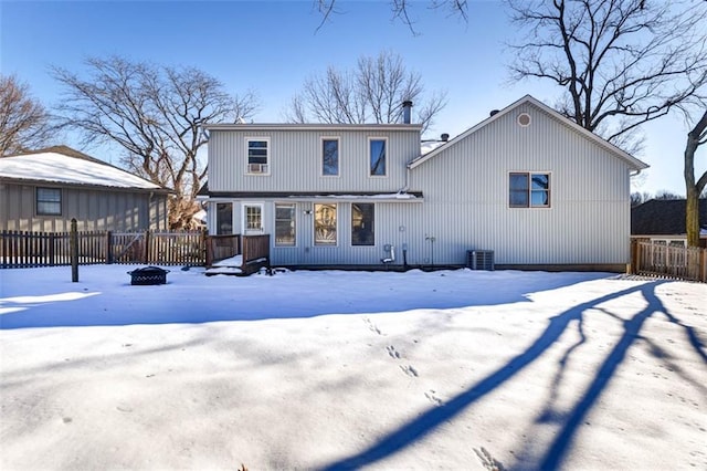 snow covered house featuring a deck and central AC unit