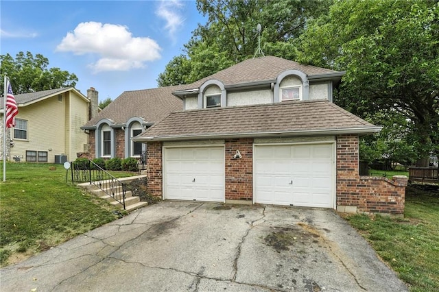 4722 Switzer Rd, Shawnee, KS 66203 - view of front facade featuring asphalt driveway, a shingled roof, a front lawn, and brick siding