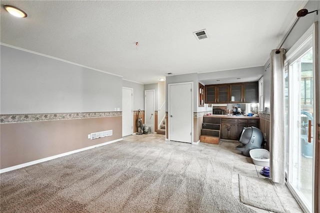 4722 Switzer Rd, Shawnee, KS 66203 - living room with light carpet, stairs, crown molding, and a textured ceiling