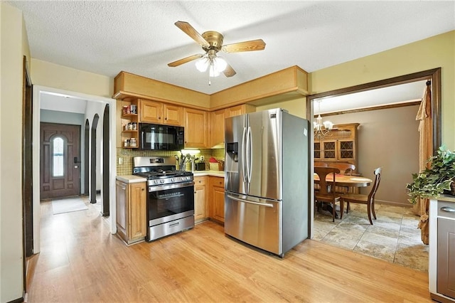 4722 Switzer Rd, Shawnee, KS 66203 - kitchen with appliances with stainless steel finishes, light wood-type flooring, light countertops, a chandelier, and a textured ceiling
