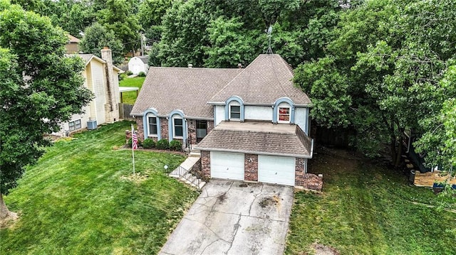 4722 Switzer Rd, Shawnee, KS 66203 - view of front of house featuring a front yard, driveway, a garage, and brick siding