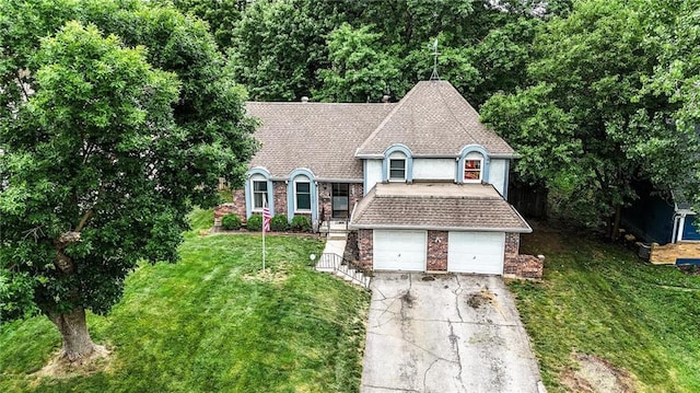 4722 Switzer Rd, Shawnee, KS 66203 - view of front of property with concrete driveway, a front yard, brick siding, a shingled roof, and stucco siding
