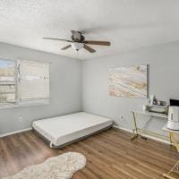 bedroom with dark wood-type flooring and ceiling fan