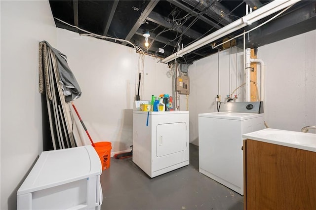 clothes washing area featuring sink, separate washer and dryer, and electric panel