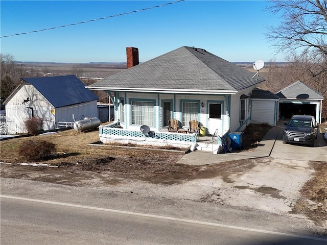 back of property featuring a porch and a garage