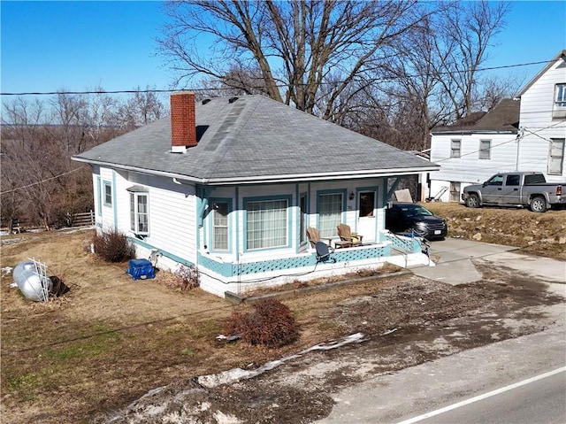 back of house featuring covered porch