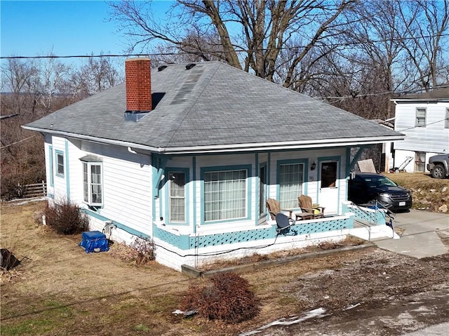 back of house with a yard and covered porch