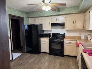 kitchen featuring exhaust hood, ceiling fan, dark hardwood / wood-style flooring, a textured ceiling, and black appliances