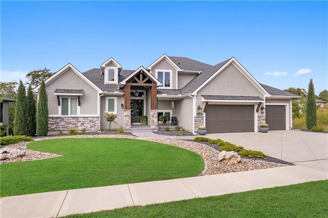 view of front of house with a front yard, stone siding, driveway, and stucco siding