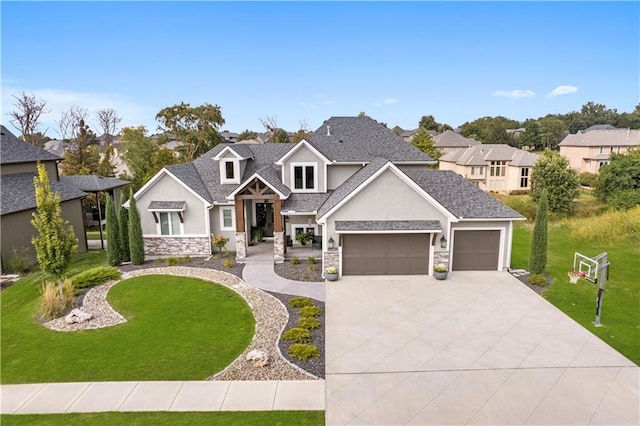 view of front of property with stone siding, an attached garage, driveway, and a front lawn