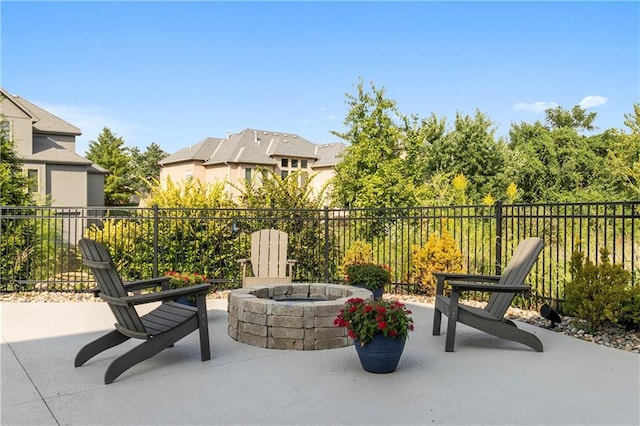 view of patio / terrace featuring an outdoor fire pit and fence