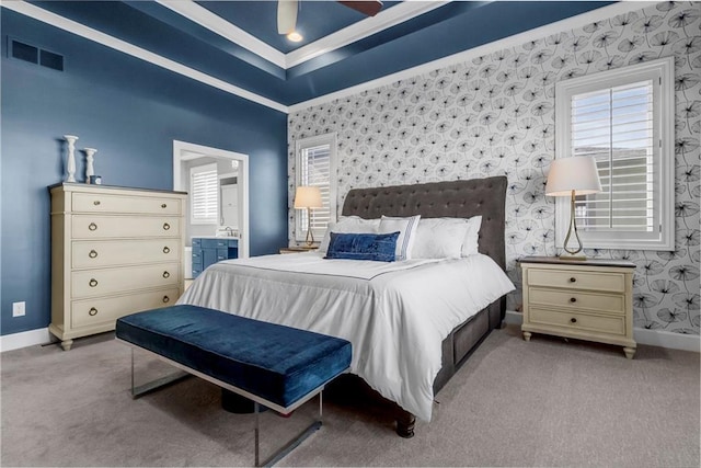 carpeted bedroom with visible vents, ensuite bath, baseboards, and wallpapered walls