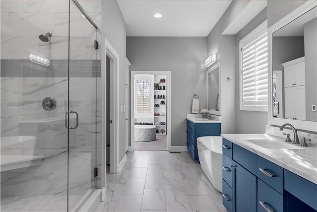 full bath featuring marble finish floor, a shower stall, and a sink