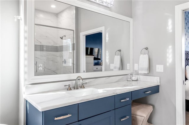 ensuite bathroom featuring a shower stall, ensuite bathroom, and vanity