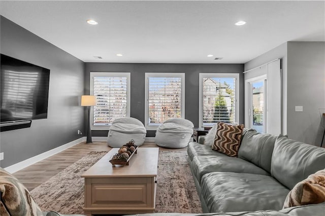 living room featuring light wood-style floors, recessed lighting, and baseboards