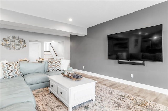 living area featuring light wood-style floors, recessed lighting, stairway, and baseboards