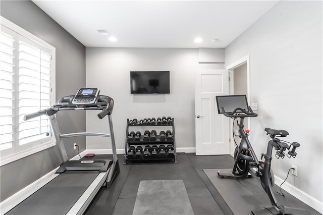 workout area with visible vents, baseboards, a wealth of natural light, and recessed lighting