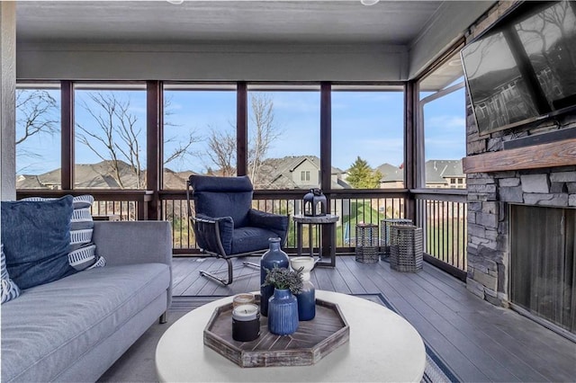 sunroom featuring a fireplace