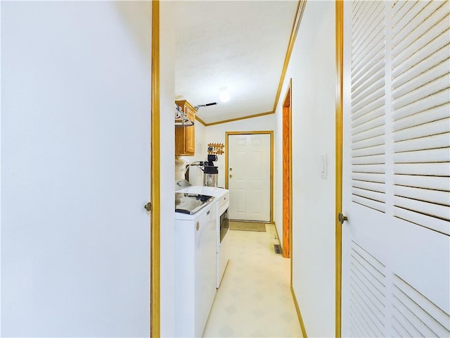 interior space featuring lofted ceiling, washing machine and dryer, and crown molding