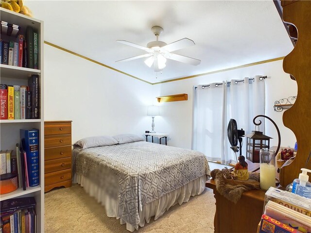 bedroom with ceiling fan, light colored carpet, and crown molding