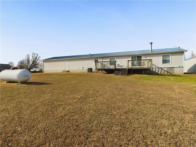 back of house with a deck and a yard