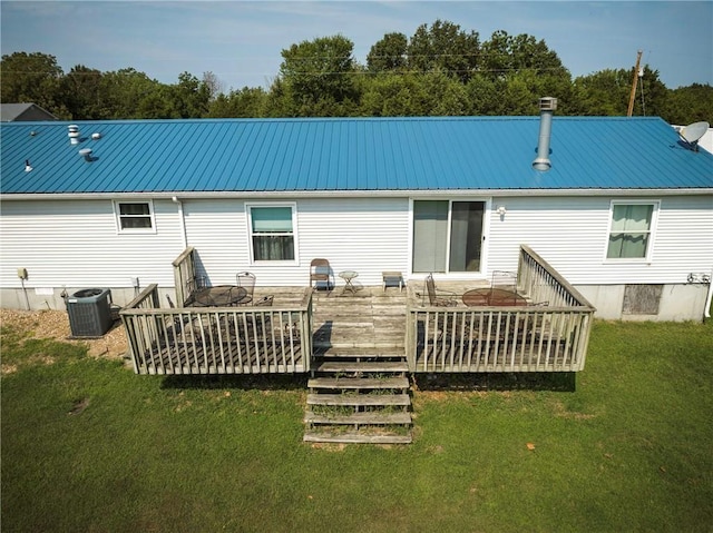 back of house with a deck, a yard, and central AC