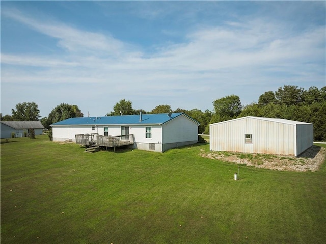 back of property with a deck and a yard