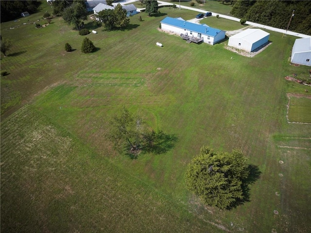 birds eye view of property with a rural view