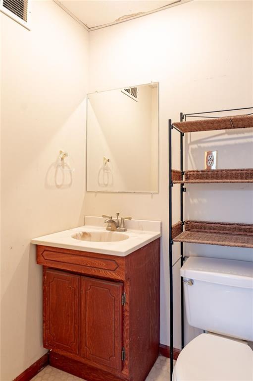 bathroom featuring toilet and vanity