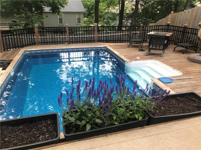 view of swimming pool featuring a wooden deck