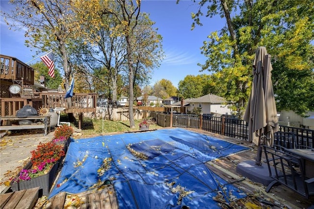 wooden terrace with a covered pool