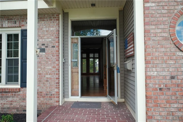 property entrance with brick siding