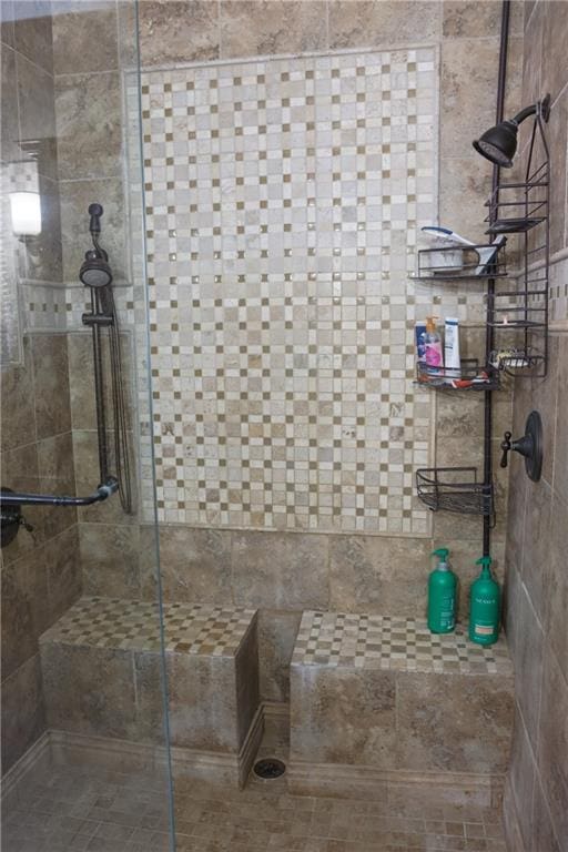 full bath with a tile shower