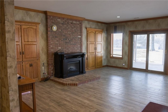 unfurnished living room featuring baseboards, ornamental molding, and light wood-style flooring