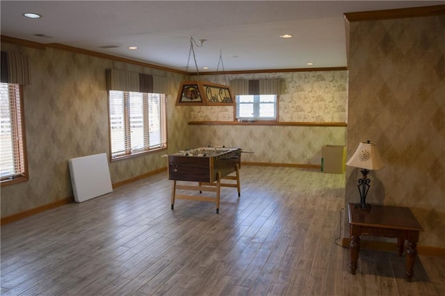dining area with wood finished floors, recessed lighting, crown molding, baseboards, and wallpapered walls