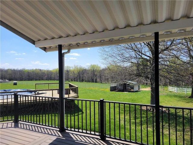 wooden terrace with a lawn