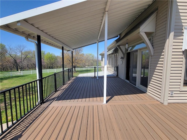 wooden terrace with a yard and fence