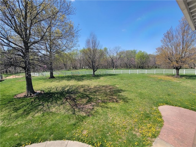 view of yard with a rural view and fence