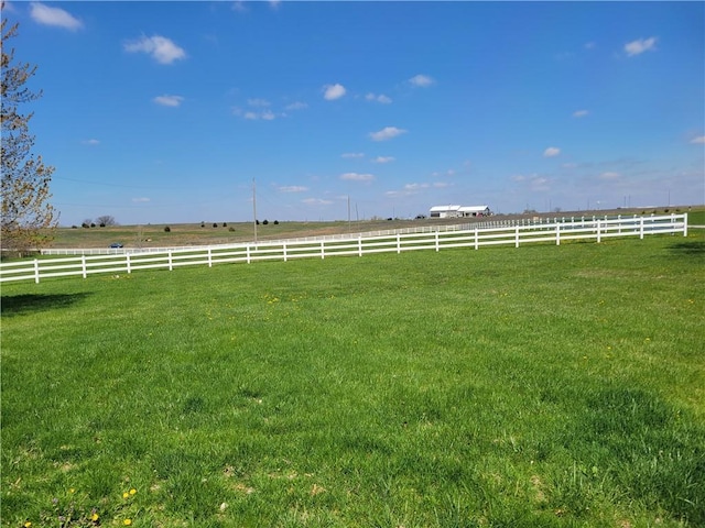 view of yard featuring a rural view and fence