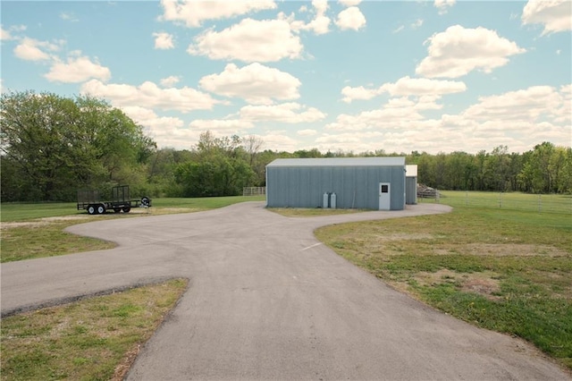 view of road with an outbuilding and aphalt driveway