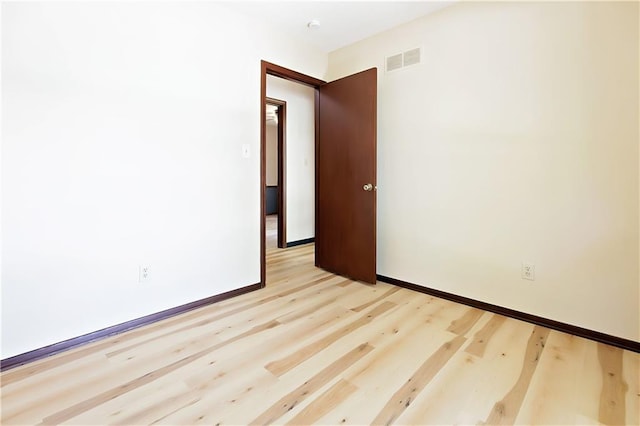 spare room with light hardwood / wood-style flooring