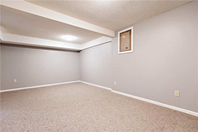 basement featuring carpet floors and a textured ceiling