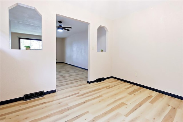 unfurnished room with ceiling fan and light wood-type flooring