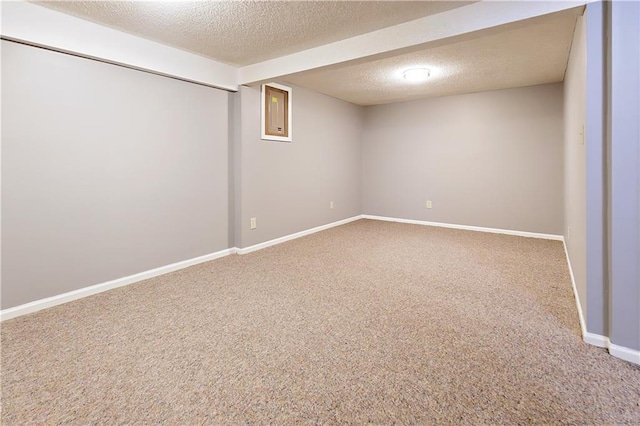 basement with a textured ceiling and carpet floors