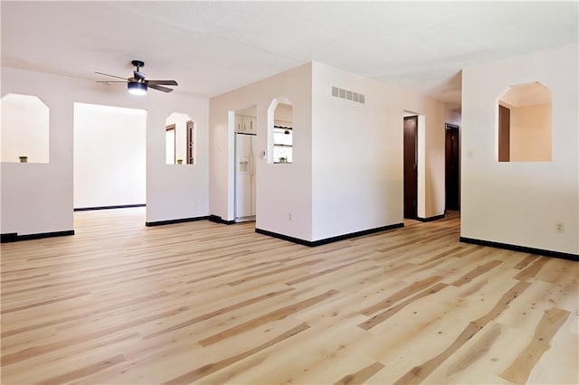 spare room with light wood-type flooring and ceiling fan